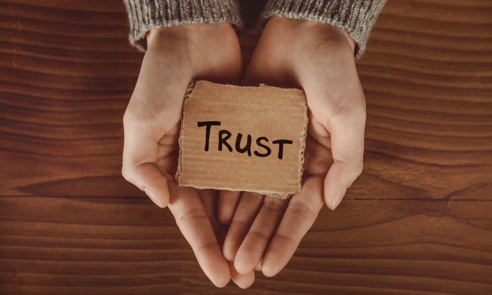 Picture showing hands holding a piece of paper with trust